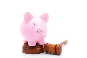piggy bank and a legal gavel, on white